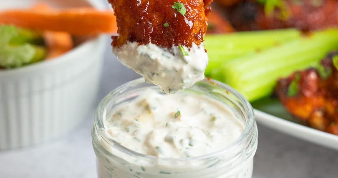 chicken wing dipping inside blue cheese