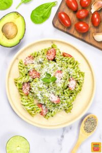 a completed plate of creamy avocado pasta with garnish added