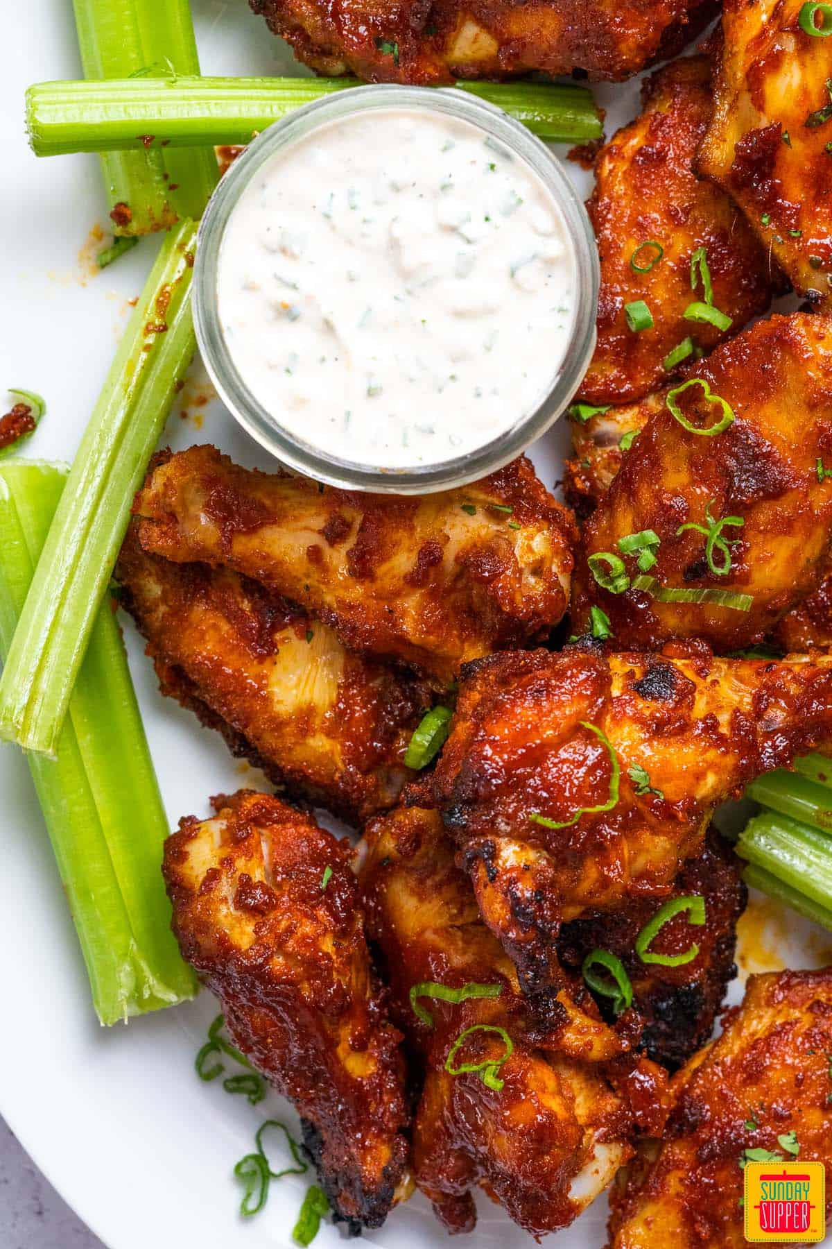 close up chicken wings with celery and ranch
