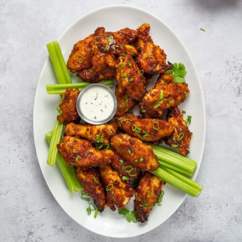 crock pot chicken wings on a plate with celery and ranch