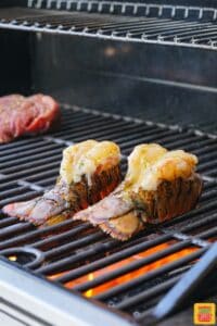 two lobster tails on the grill