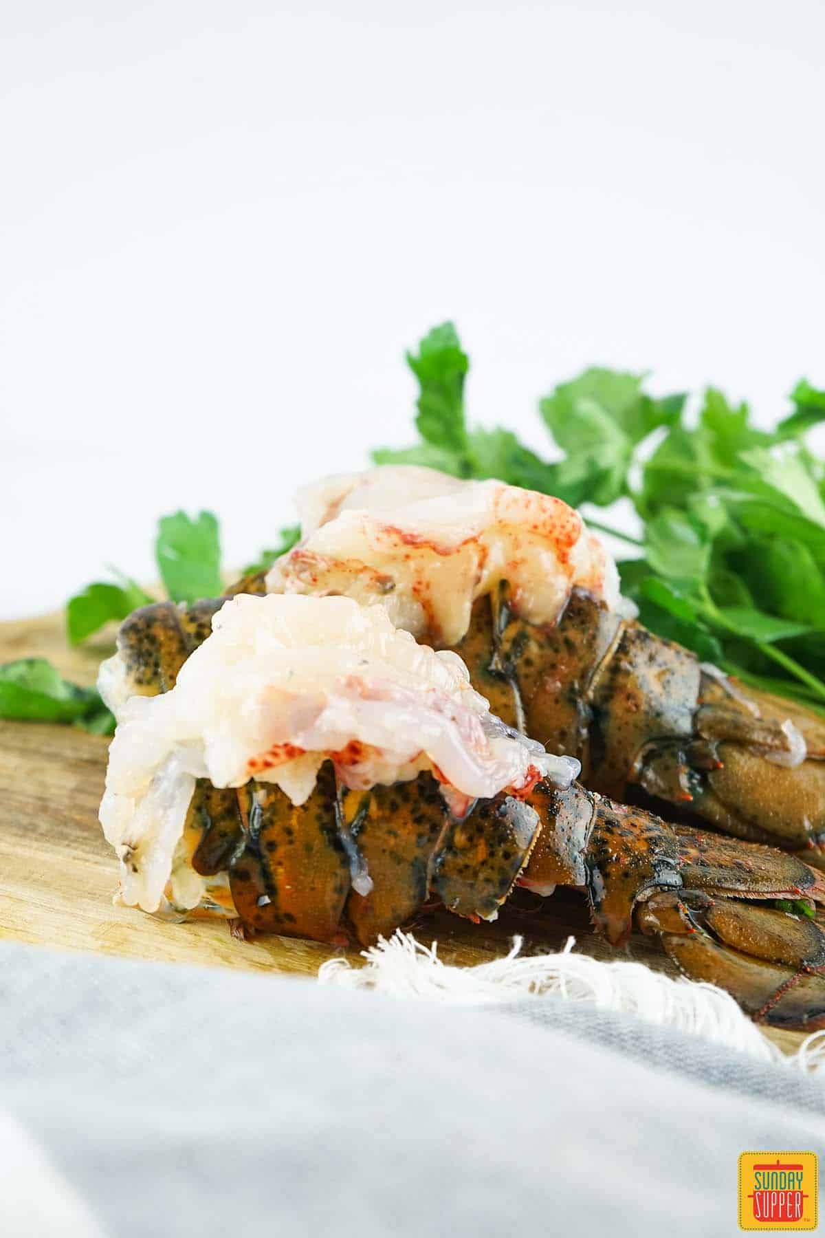 two lobster tails with meat set on top of shell