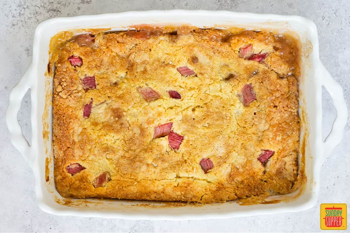 rhubarb dump cake after being baked in a white dish