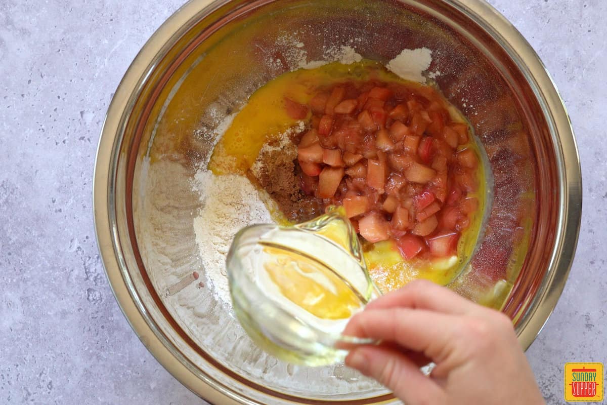 adding ingredients for rhubarb muffins
