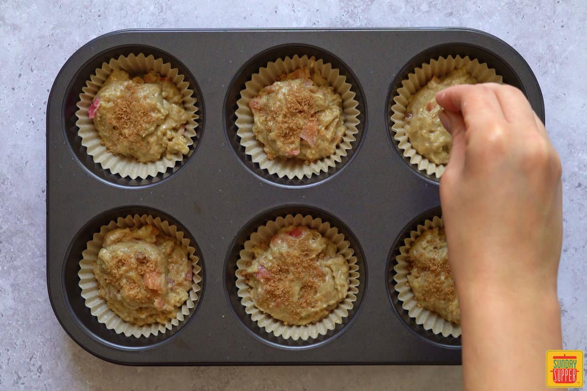 adding topping to muffins