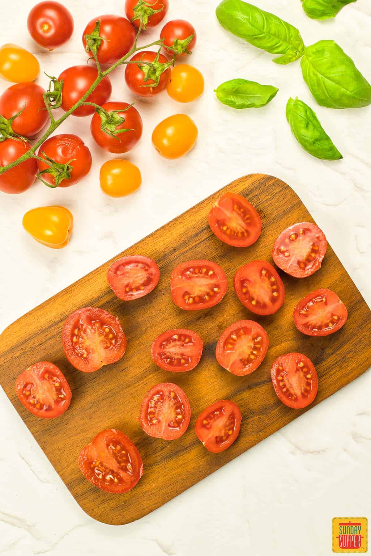 sliced cherry tomatoes on a cutting board