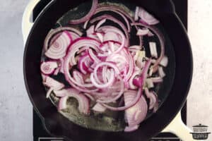 adding onions to pan with melted butter