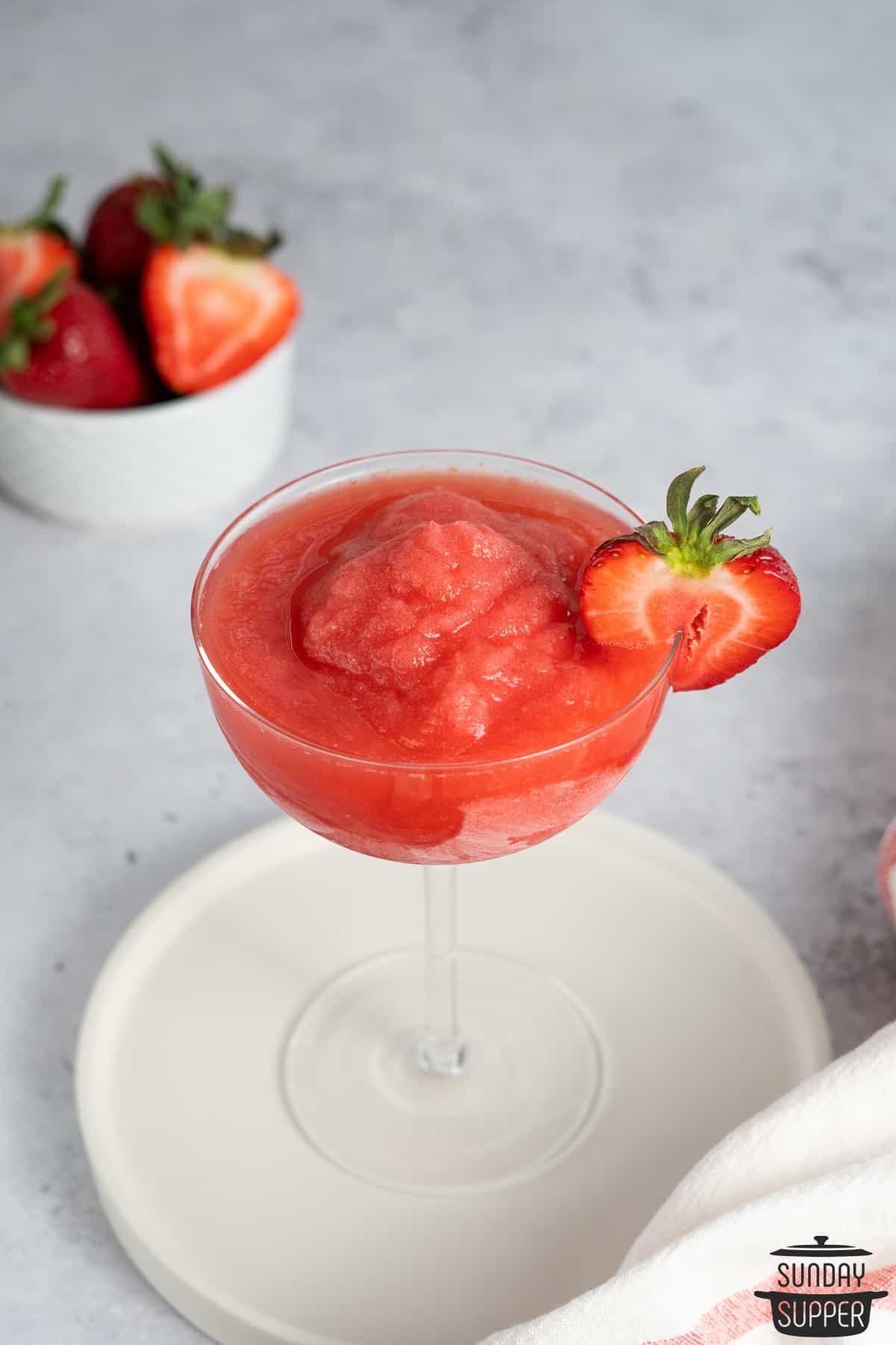 strawberry frose in a wide cocktail glass