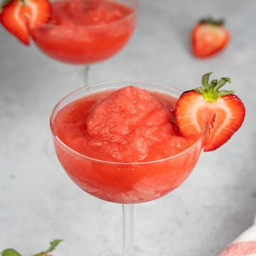 frose in a glass with a strawberry slice on the rim