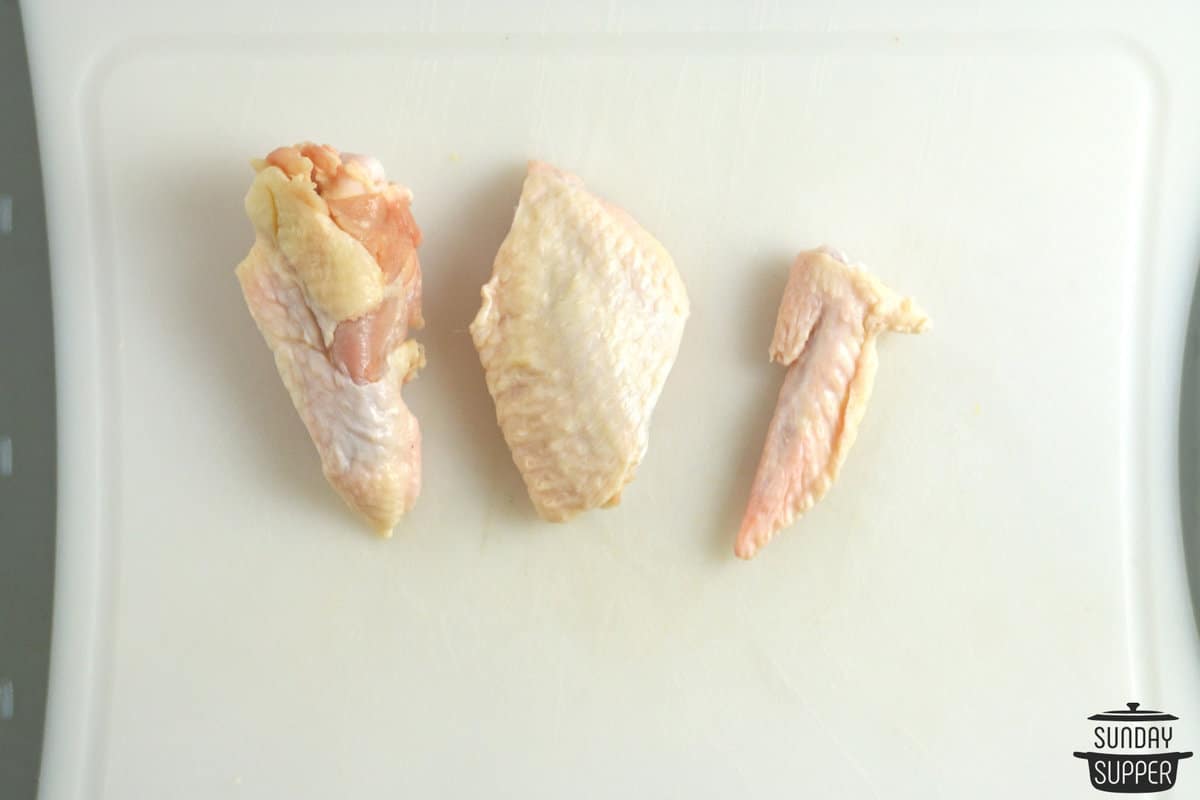 chicken wingette, drumette, and wing tip on a cutting board