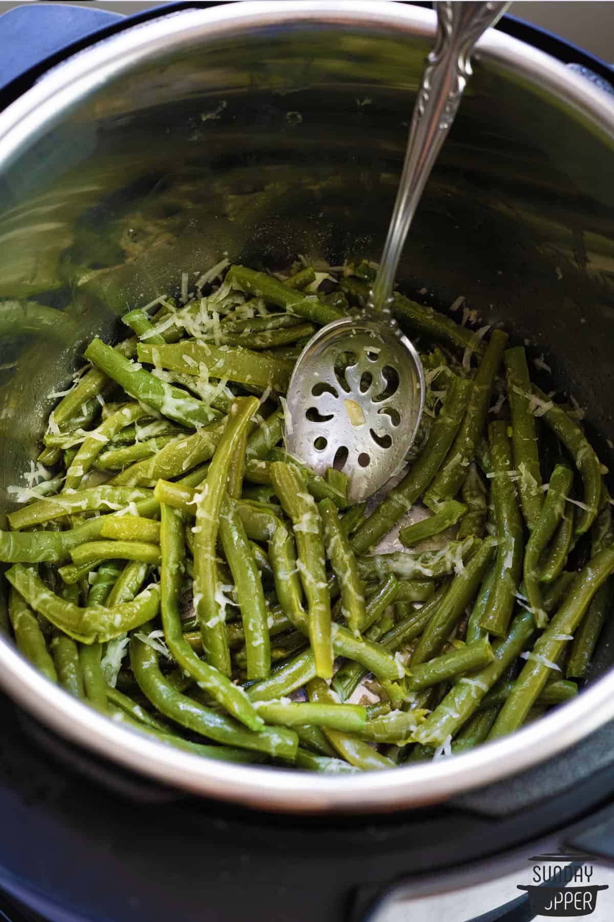 green beans and a spoon inside the instant pot