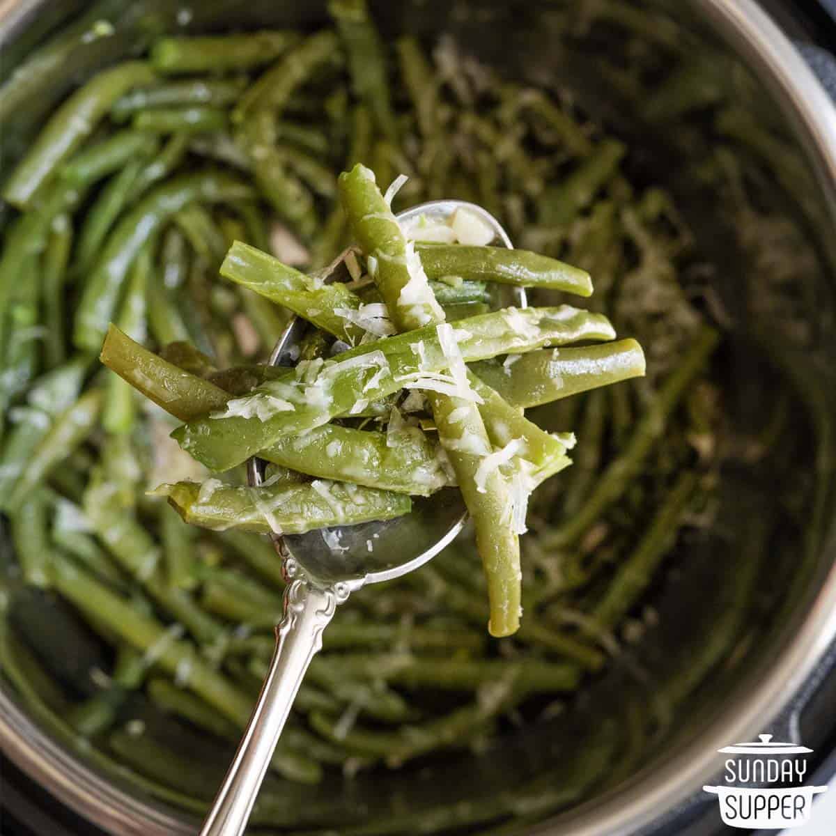 a spoon with green beans