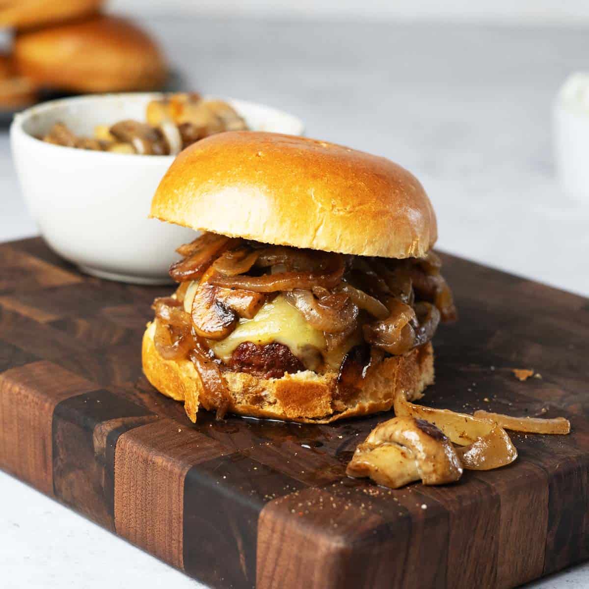 mushroom Swiss burger on a wood block