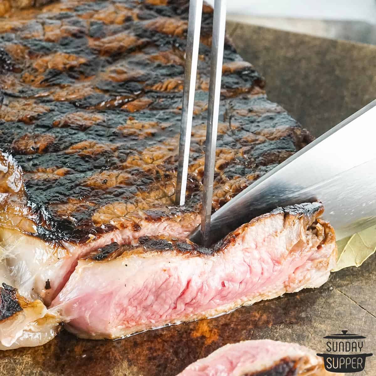 a closeup of a strip steak being sliced