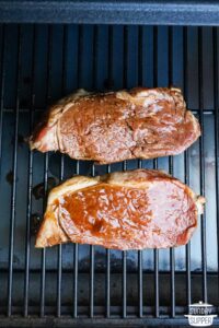 marinated steaks placed on a grill