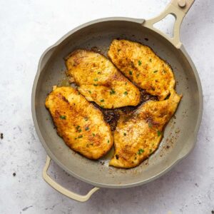 Overhead shot of pan-fried chicken in a pan