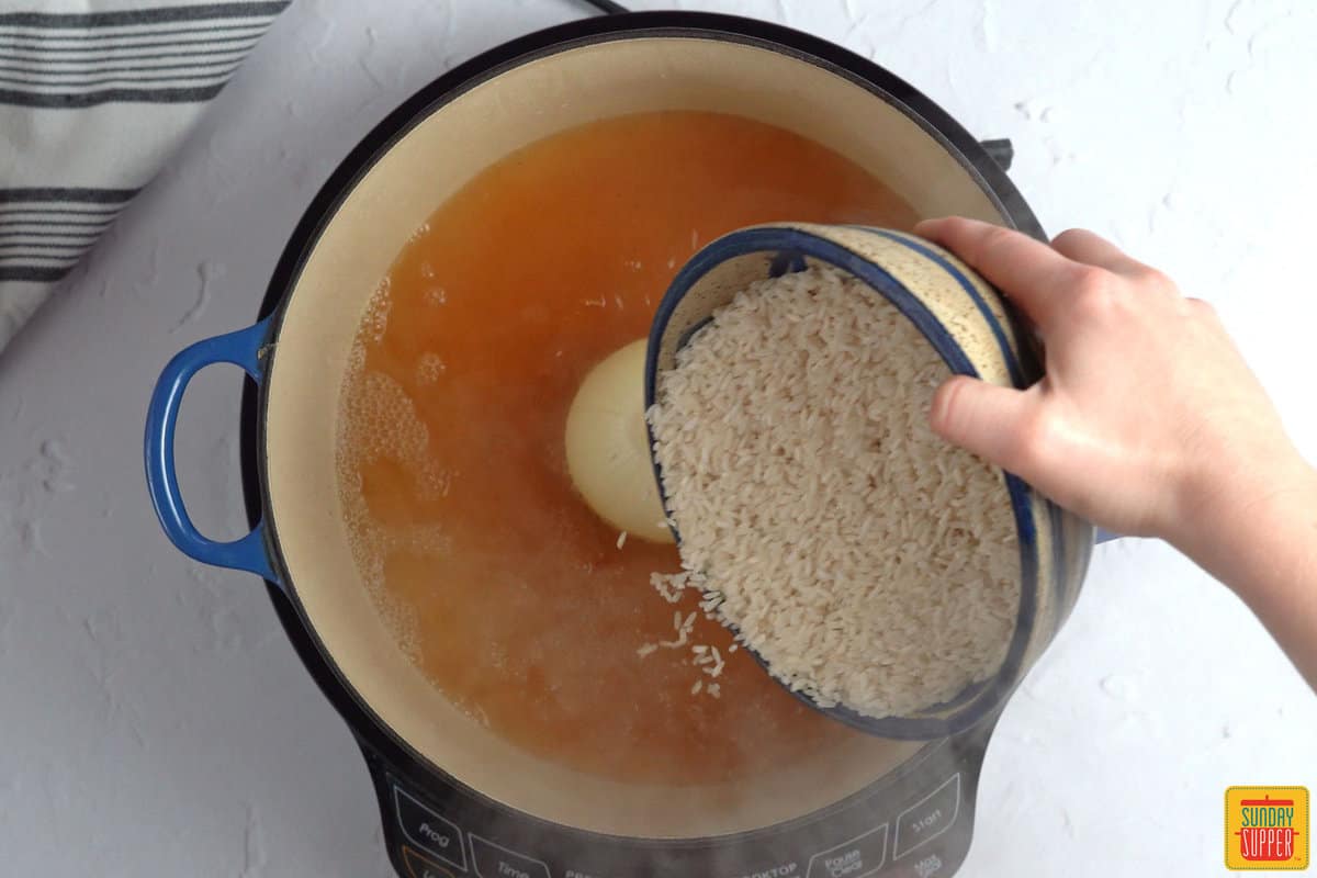 adding rice to a pot