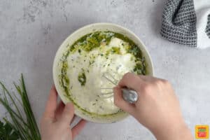 ranch dressing being mixed in a bowl