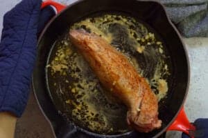 pork tenderloin cooking in pan