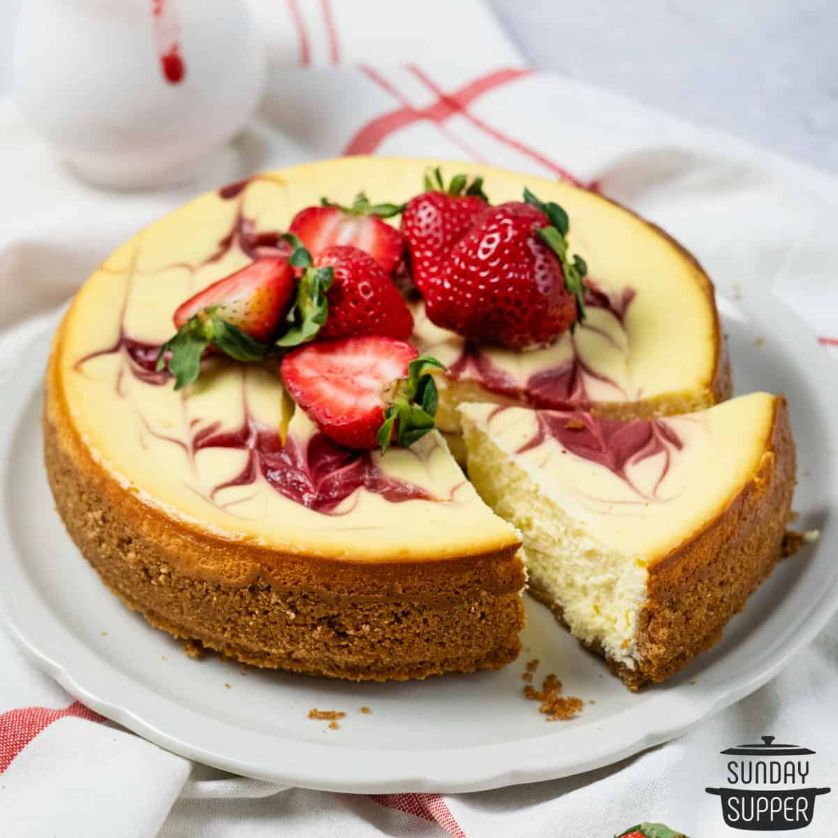 strawberry cheesecake with a slice to the side