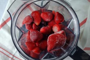 frozen strawberries inside a blender