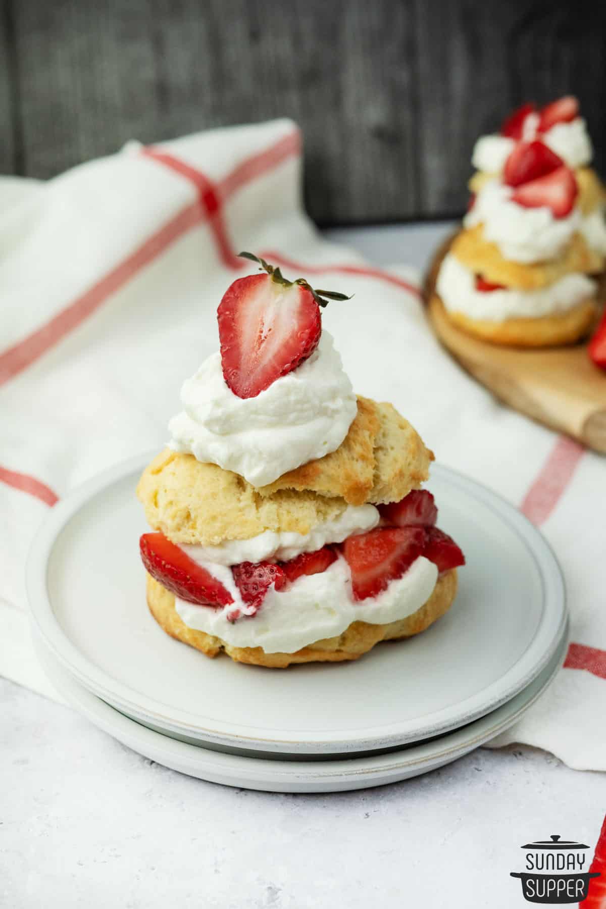 strawberry shortcake with homemade biscuits and whipped cream on a plate