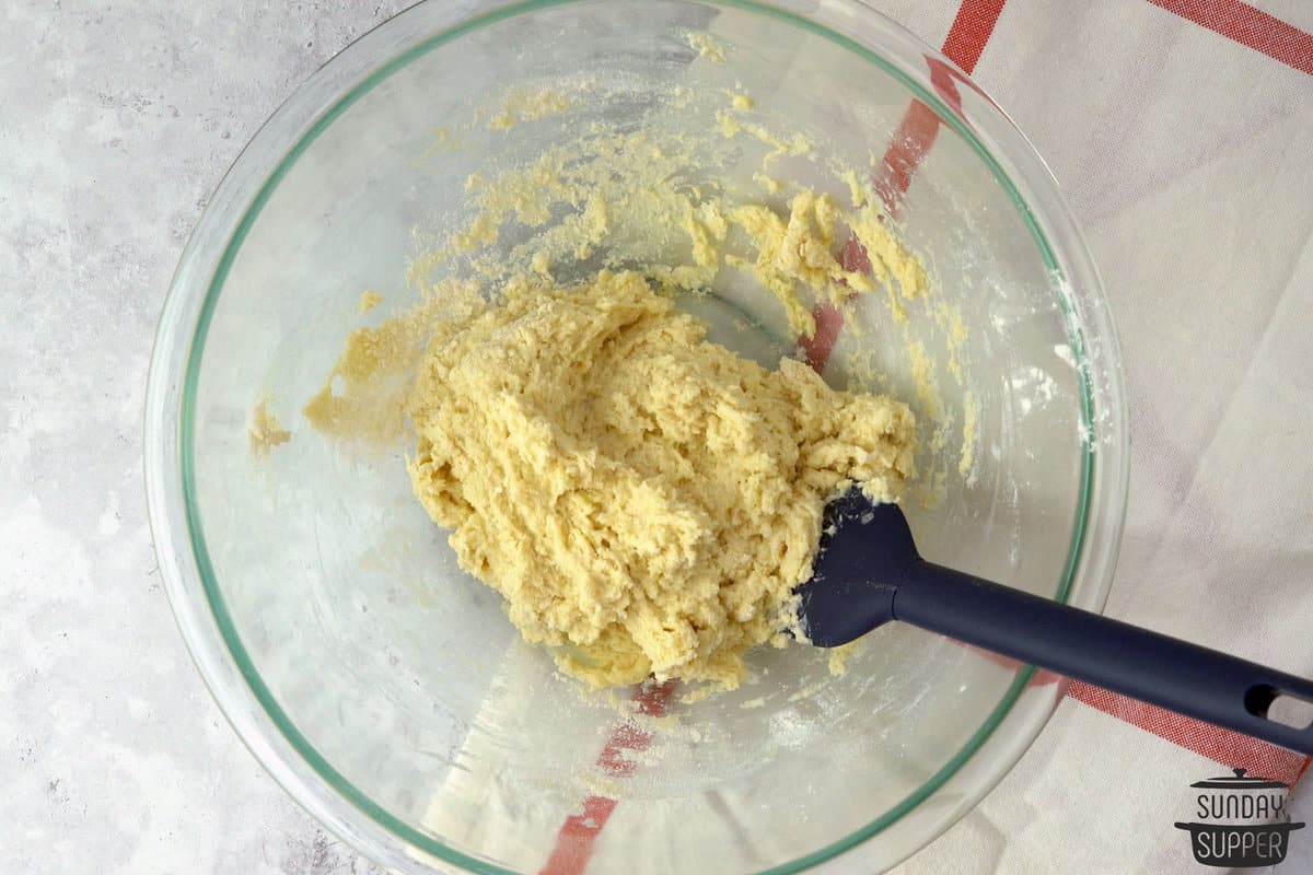 mixing batter for strawberry shortcake biscuits in a bowl