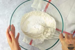 mixing dry ingredients for strawberry shortcake biscuits in a bowl