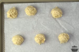 strawberry shortcake biscuit dough on parchment paper on a baking sheet