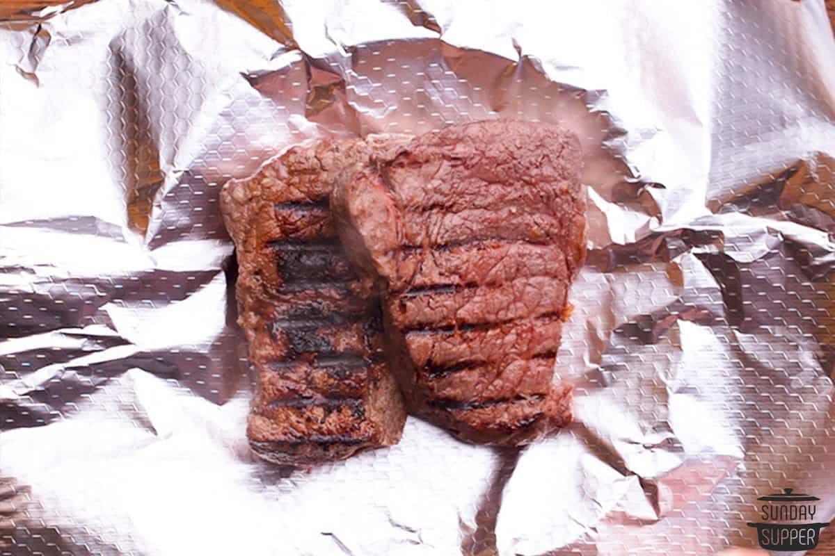 Grilled sirloin steaks on a piece of aluminum foil