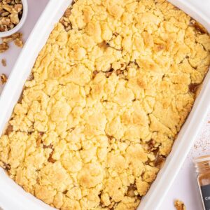 close up of apple dump cake in a white baking dish