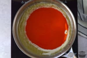 adding buffalo sauce and butter into a skillet