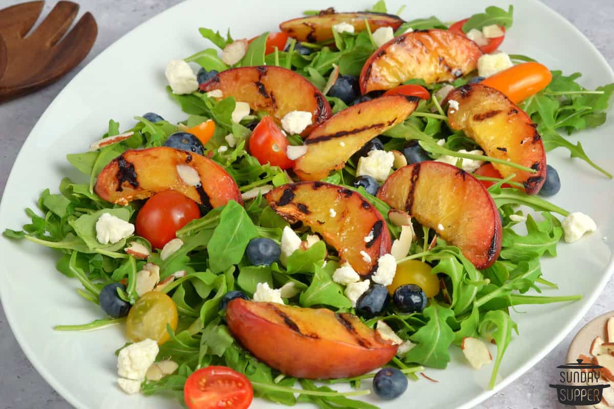 grilled peach salad on a white dish