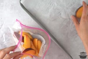 adding frozen peaches to a freezer bag
