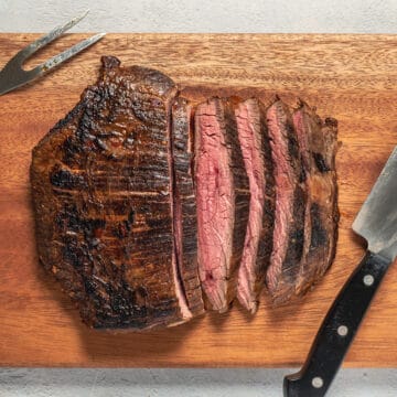 sliced flank steak on a cutting board