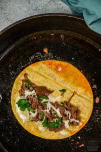 quesabirria taco frying in skillet