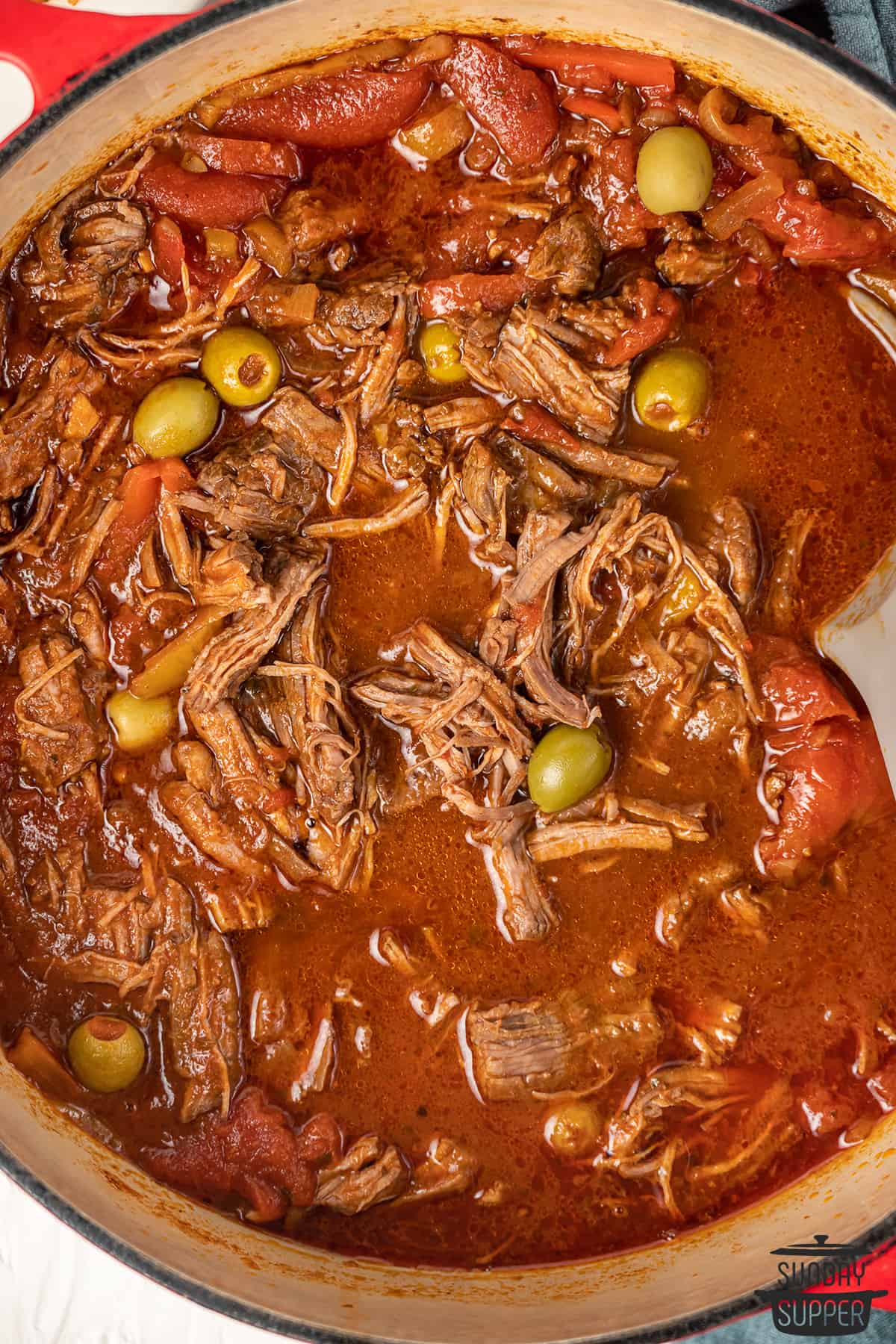 ropa vieja in a pot with olives