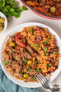 ropa vieja plated with beans and rice