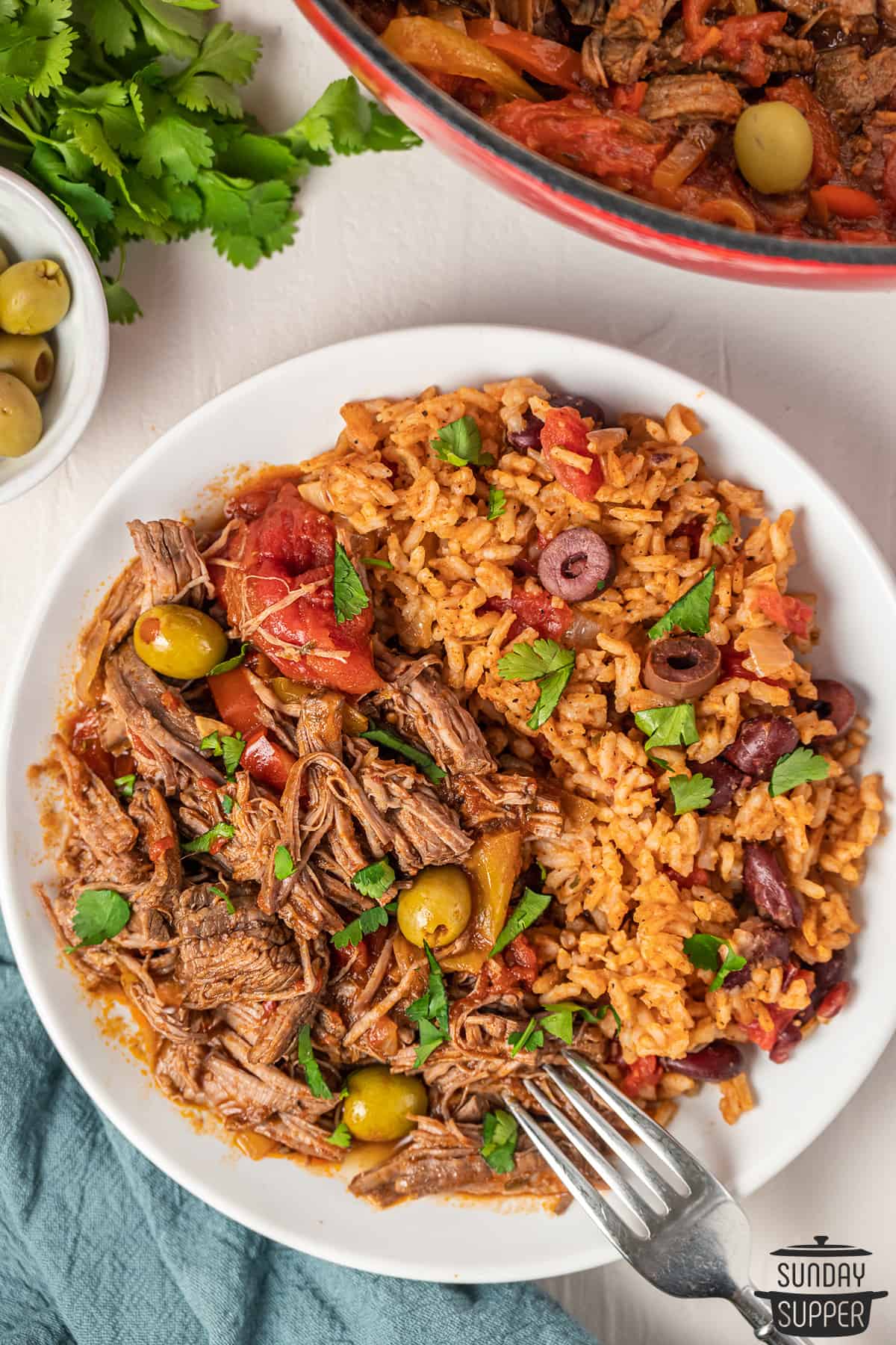 ropa vieja plated with beans and rice