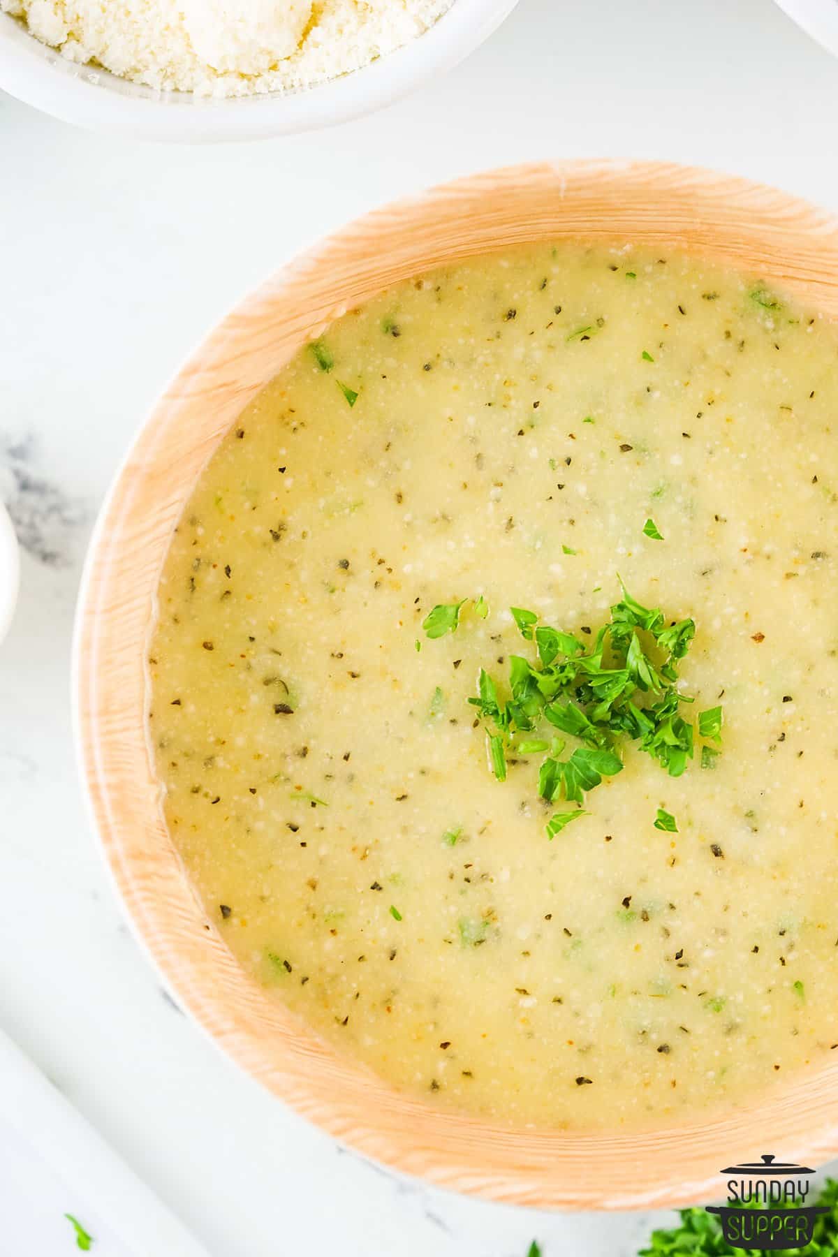 garlic parmesan sauce in a bowl with fresh parsley