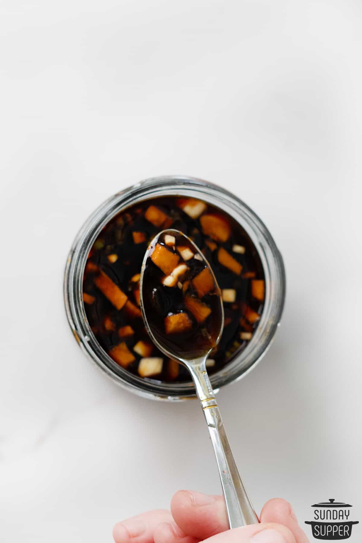 homemade teriyaki sauce in a jar with a spoon