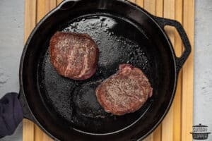 searing filet mignon in a pan