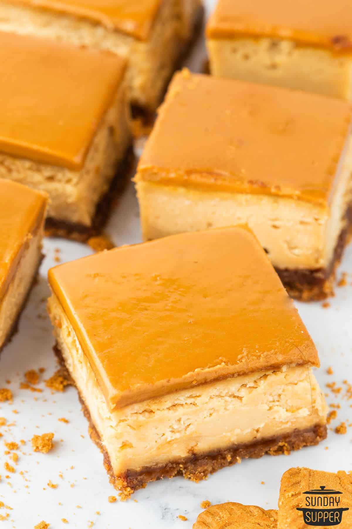 a tray filled with squares of biscoff cheesecake