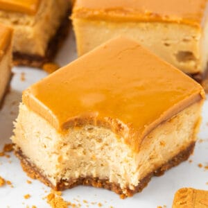 a square of biscoff cheesecake with a bite taken out of one corner