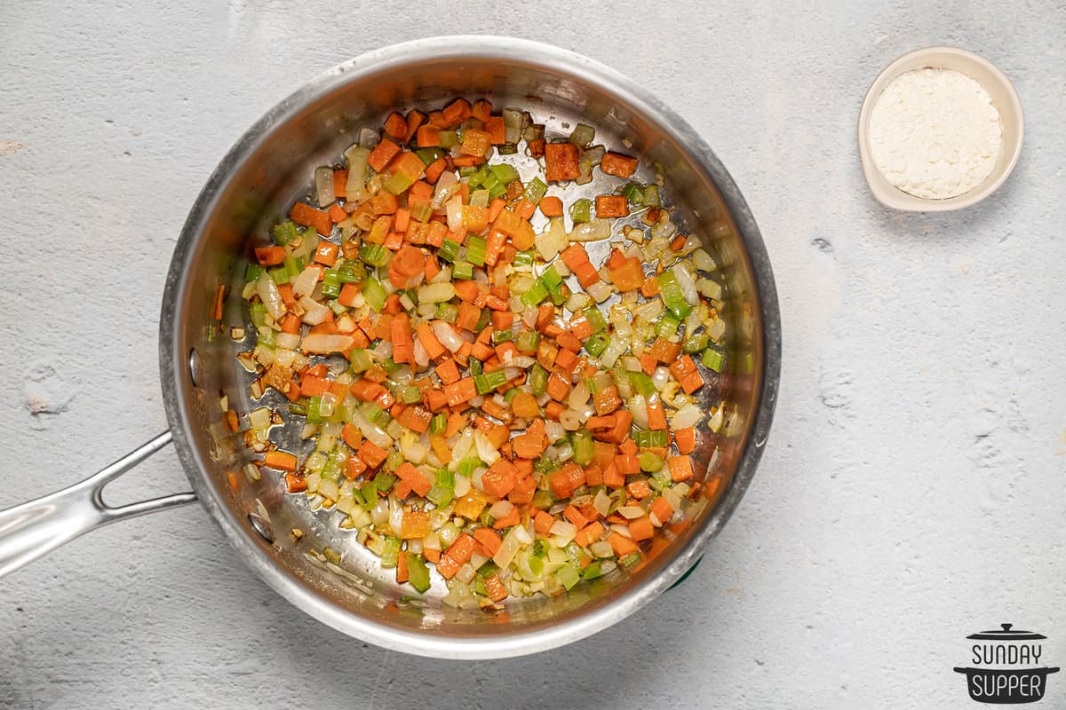 carrots, celery, and onions sauteed in a pan