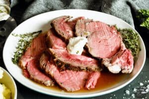 horseradish sauce with a plate of sliced prime rib