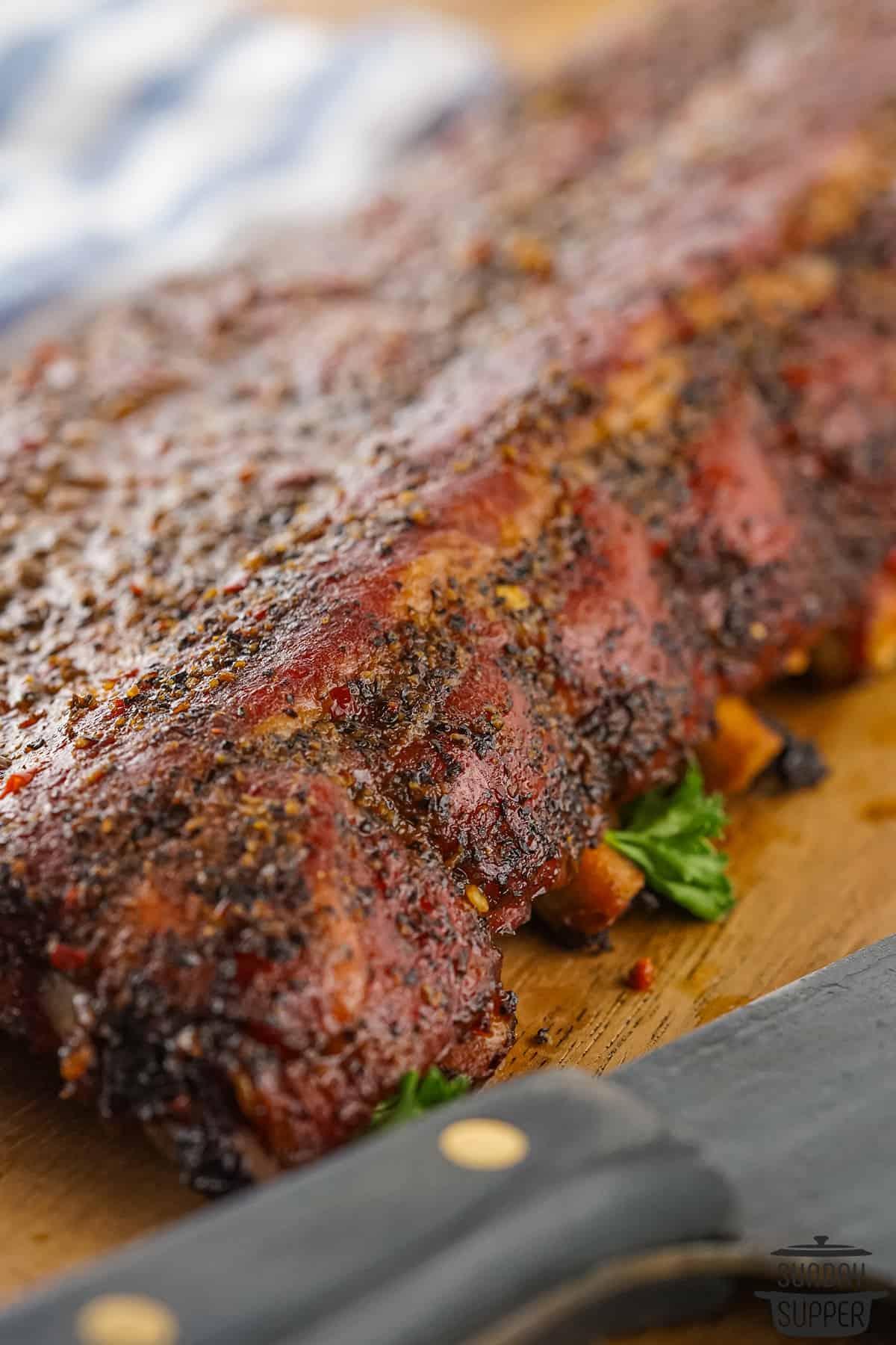smoked 3-2-1 ribs up close next to a knife