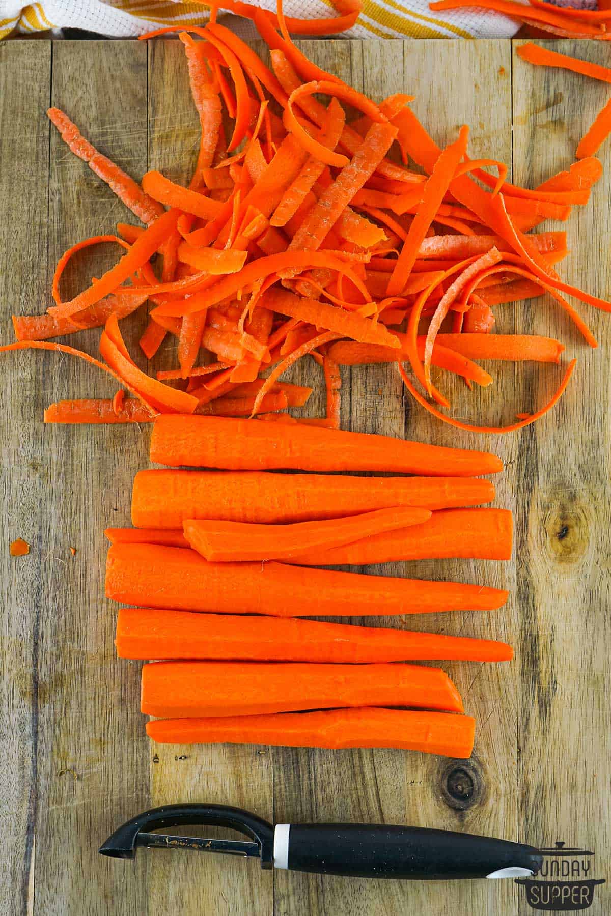 trimmed and peeled carrots on a cutting board