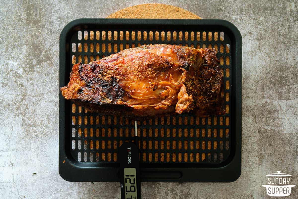 checking the internal temperature of air fryer prime rib with a meat thermometer