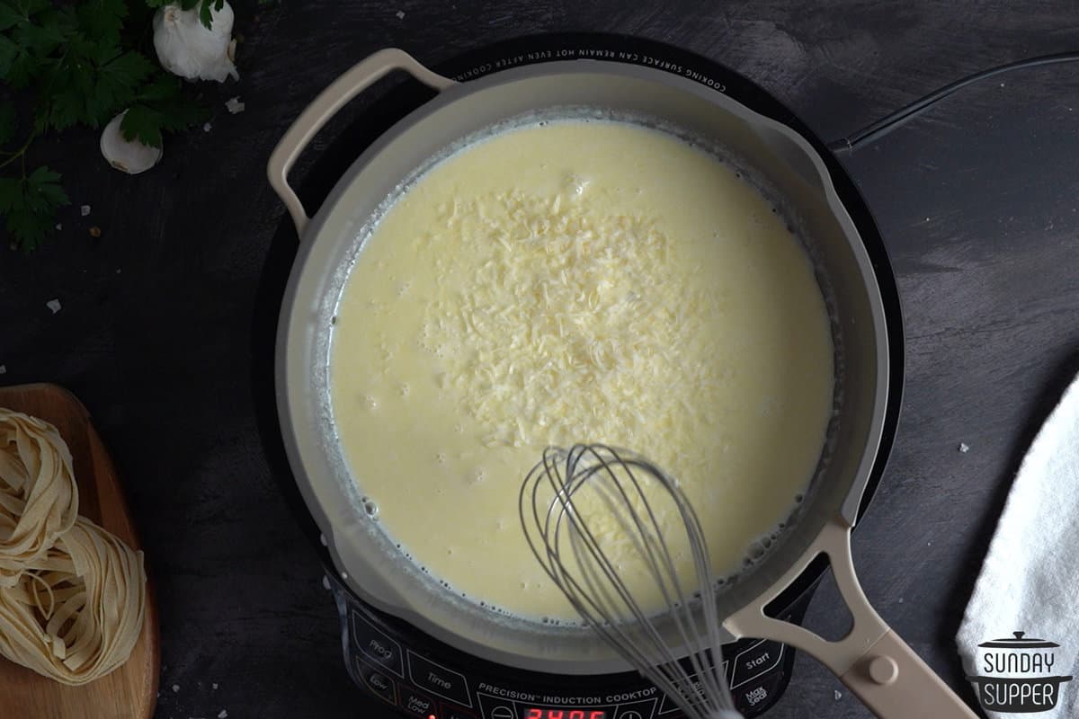 parmesan being mixed into the pot